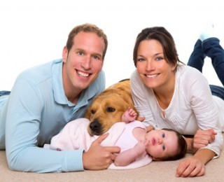 Family with new born baby and dog