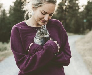 woman holding kitten